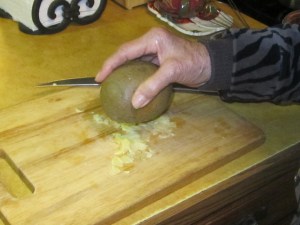 Smashing the garlic with a stone.