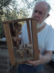 NW Mexico craft-arts collector and expert Dr.Barney T.Burns with santo of SanYsidro showing the oxen and angels.