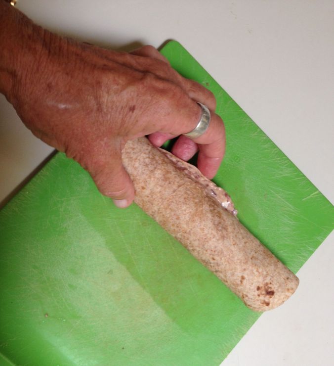 Rolling up heirloom bean hors d'oeuvres--Step 2 before cutting