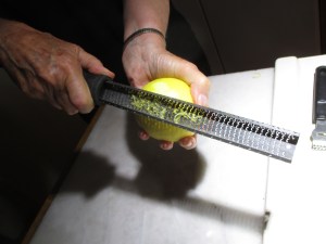 Using a microplane to make lemon zest.