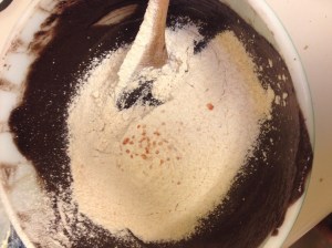 Adding White Sonora Wheat flour and crushed chiltepin to molten chocolate mixture