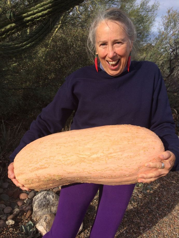 Just for scale, Tia Mart hefts this heirloom Navajo squash. Who needs a workout center if you are a gardener or farmer?