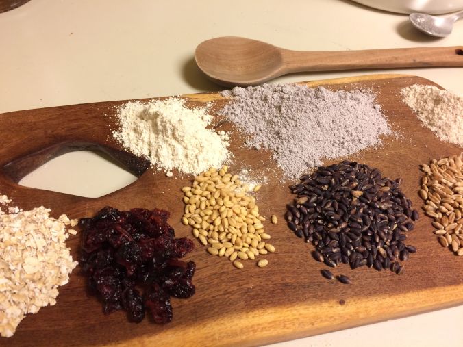 Ingredients for baking Valentine cookies--L to R rolled oats, dry cranberries, White Sonora wheat-berries and flour, Purple Prairie grain and lavender flour, local hard red wheat kernels and flour