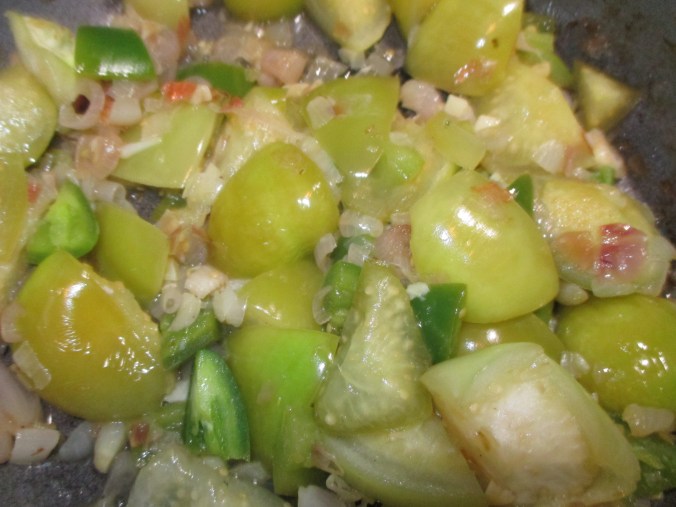 Saute the onion, garlic, and tomatillos until soft.