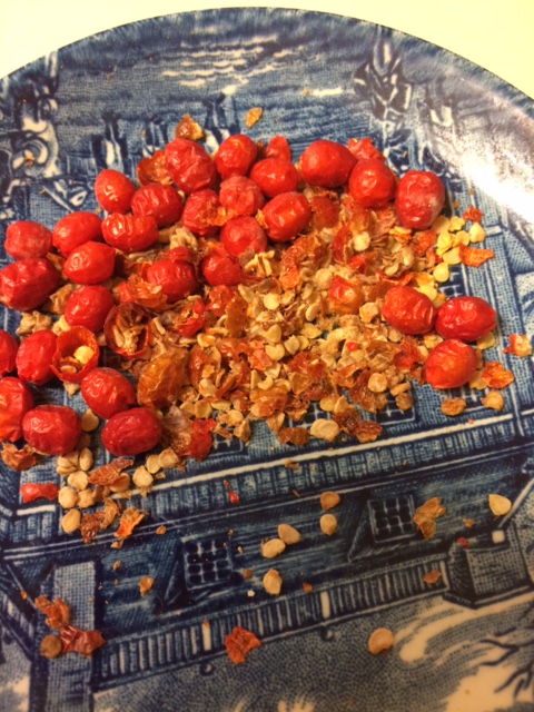 Home-grown chiltepin peppers crushed and ready to spice up a local pizza--Look out for a wave of picante heat even with a small pinch!