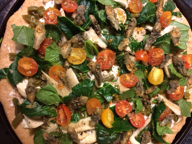 Totally local veggie pizza with cholla buds, nopalitos, acelgas, mushrooms, goat cheese and home-grown cherry tomatoes--ready to bake