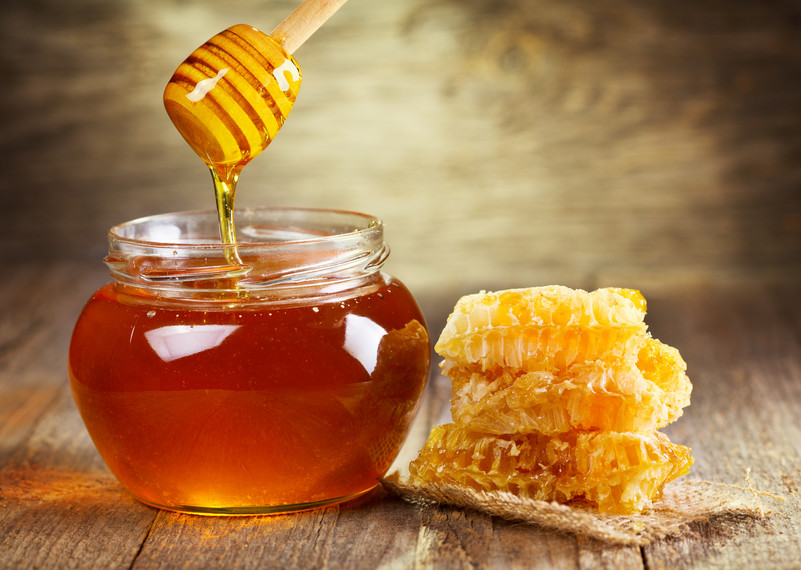 jar of honey with honeycomb